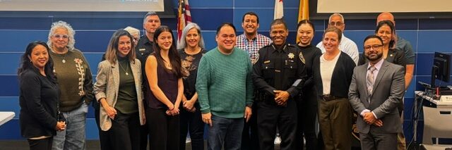Image of community members at a Community Policy Working Group meeting